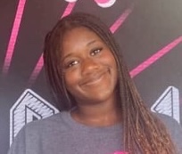 Illustrate a cozy design consultation scene with a couple discussing their ideas with a DWELLINE designer. Warm lighting should envelop the space, complementing the stylishly arranged design materials and color samples scattered around. A medium angle should capture the collaborative energy of the meeting.